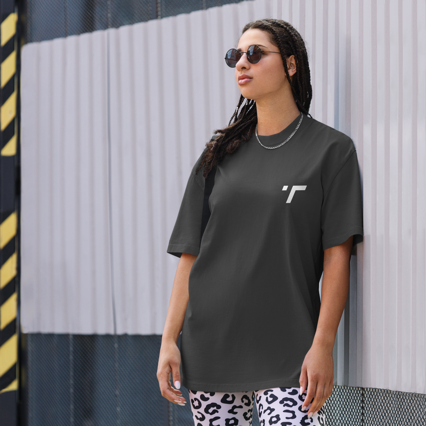 Model wearing a relaxed-fit oversized t-shirt in breathable, lightweight fabric with drop-shoulder design and longer hem. Perfect for casual wear or workouts, offering comfort and unrestricted movement